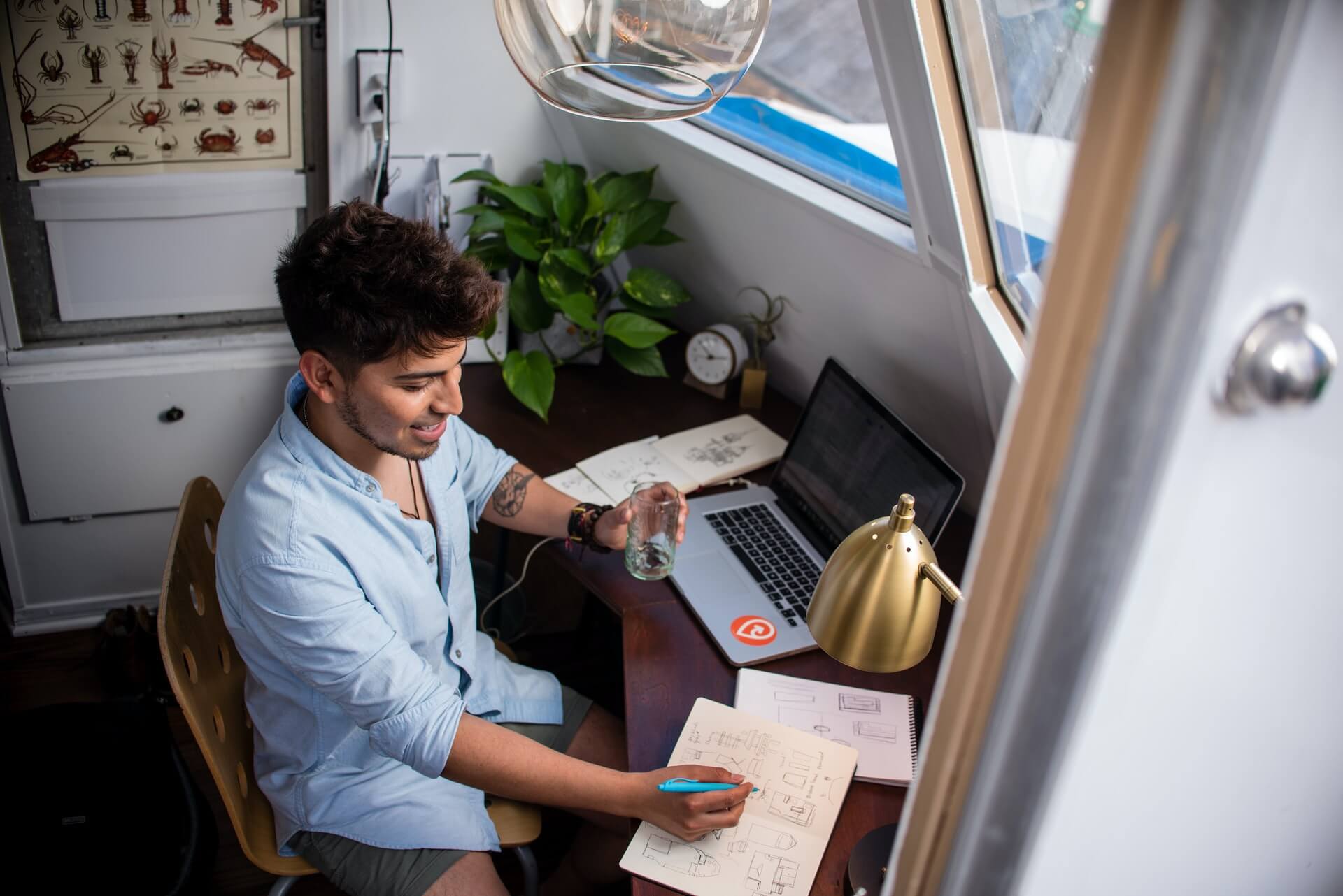 Every office department's favourite thing about never going to the office again - man in a home office with a laptop, doing technical work